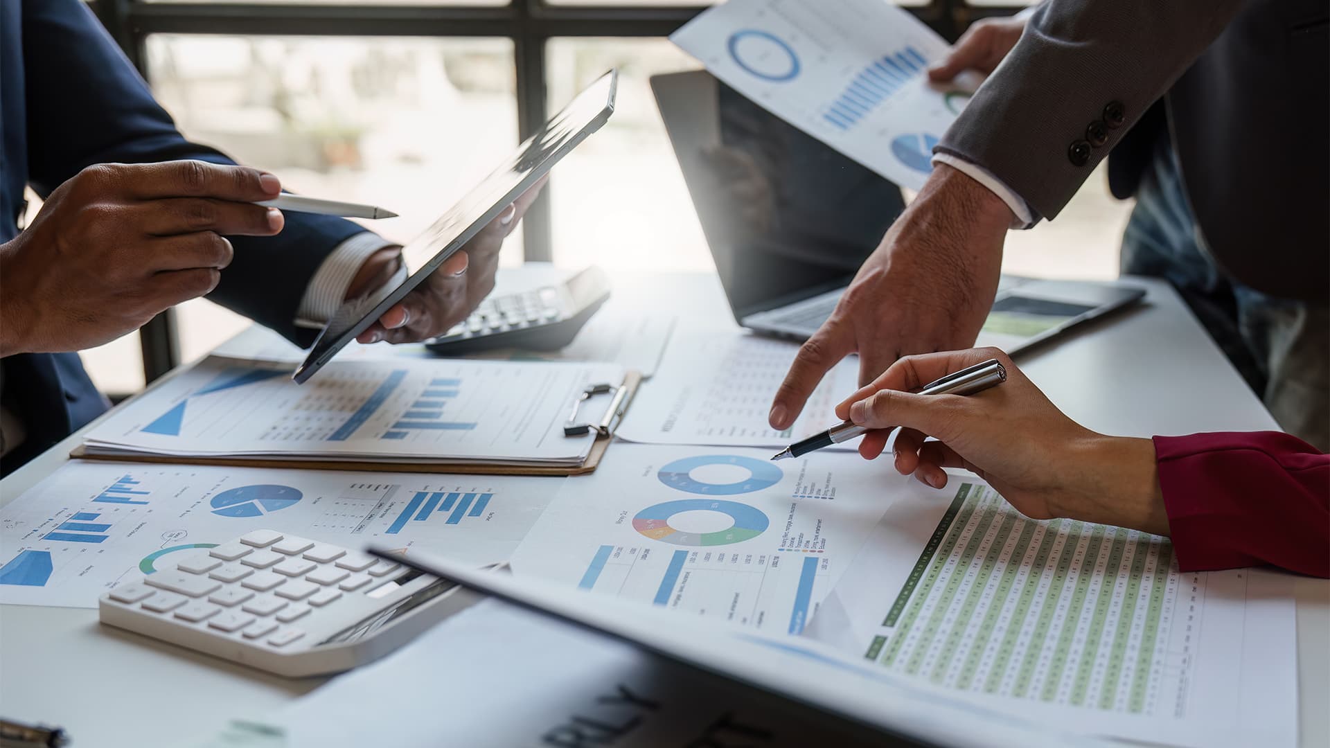Professional team analyzing financial plans, wealth strategies, and investment options, representing ADKONS Financial Advisory services.